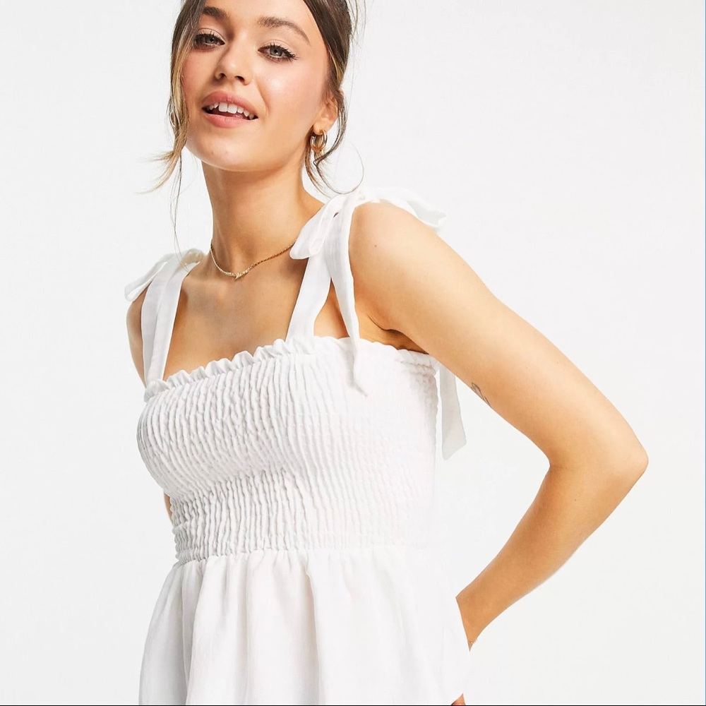 Brand NEW white w/ ties tank top. Elastic stretch across breast, flows under